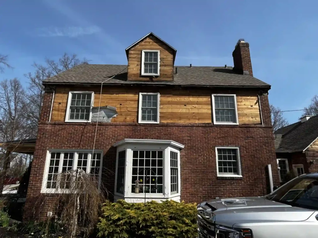 side view of home with siding removed showing old wood