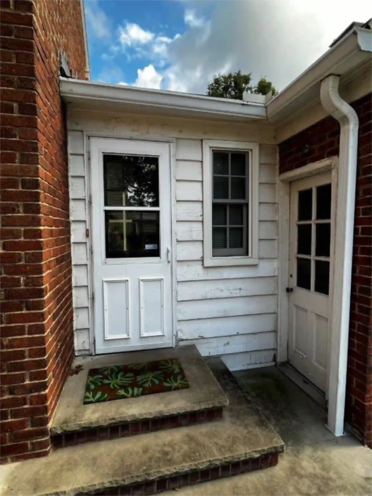 old worn out wood panel on back door of home