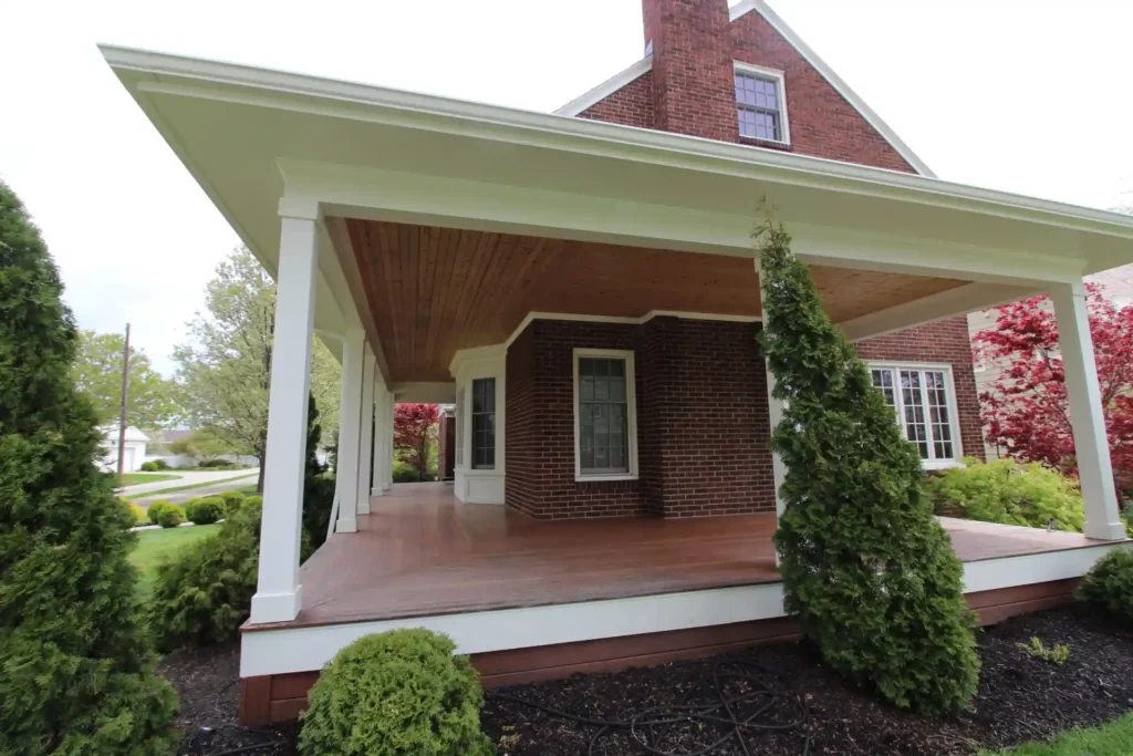 picture of large front porch with new siding, decking, and windows installed on residential home.