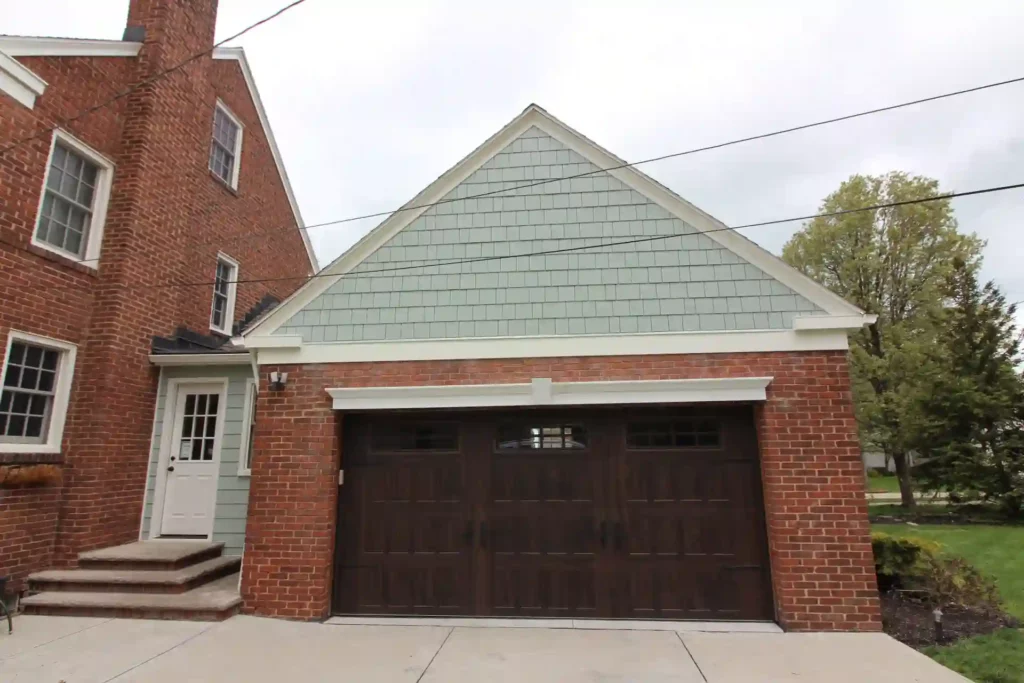 new garage door and new siding recently installed. garage door is deep brown in color