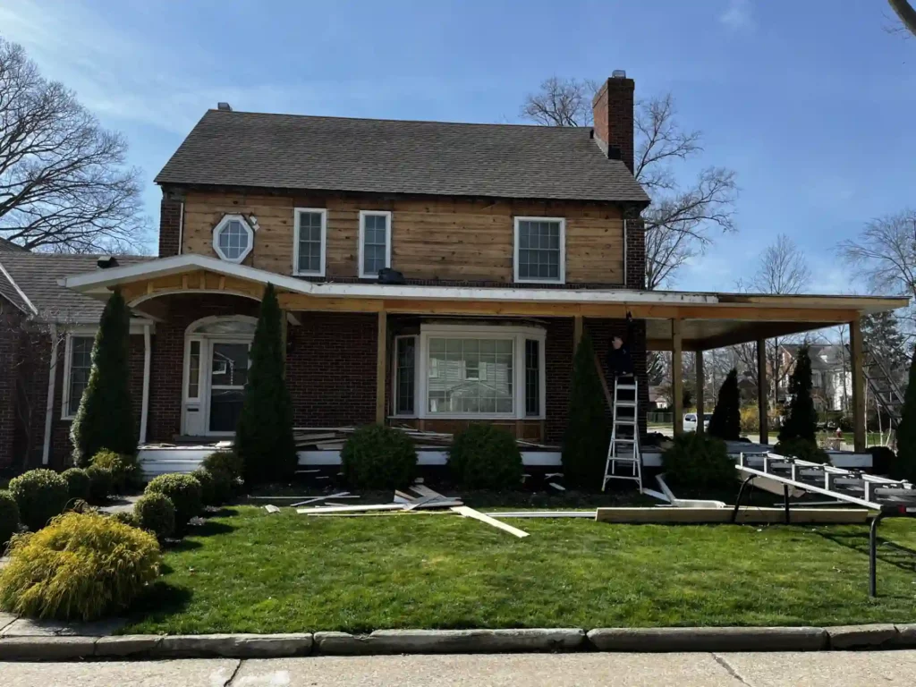 house siding under construction with bare wood on home in view