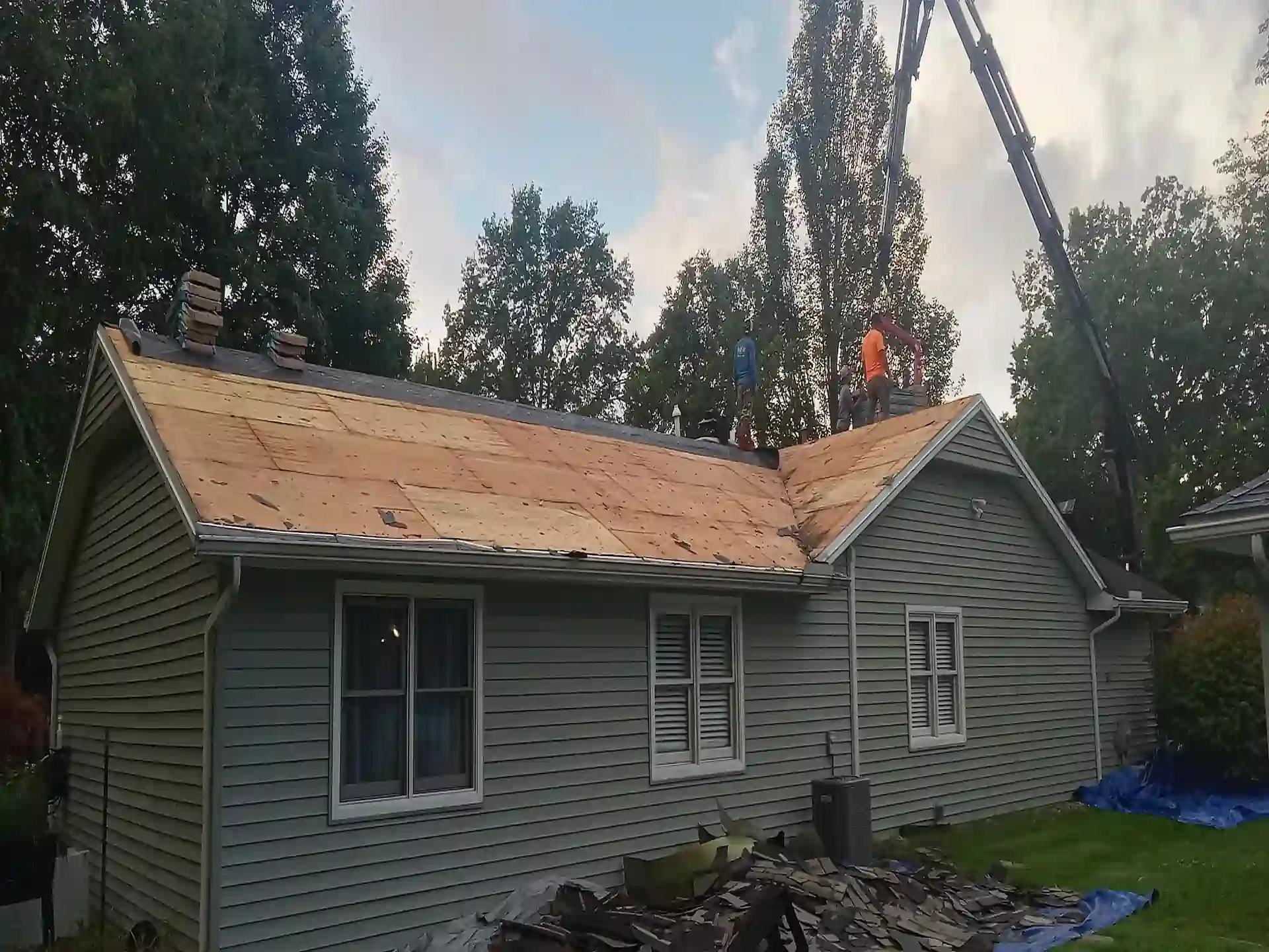 roofers working on new roof with shingles not yet on