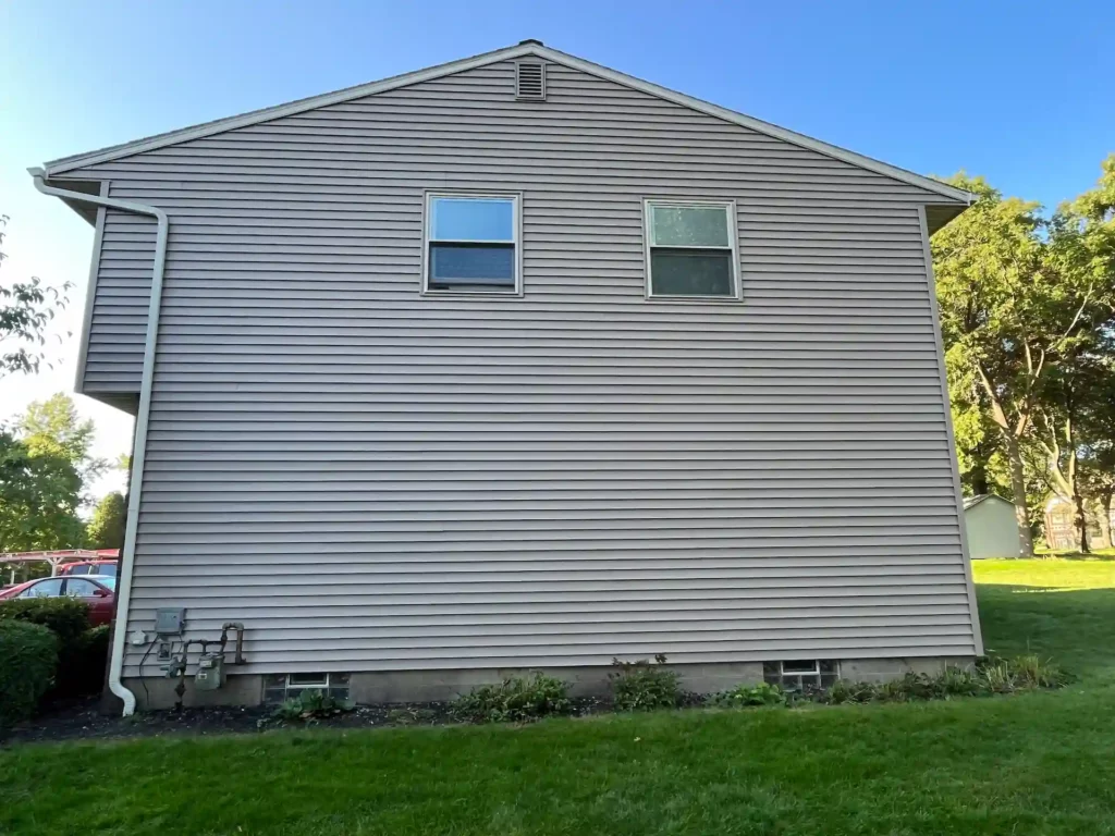 picture of the side of a two story home showing new tan siding