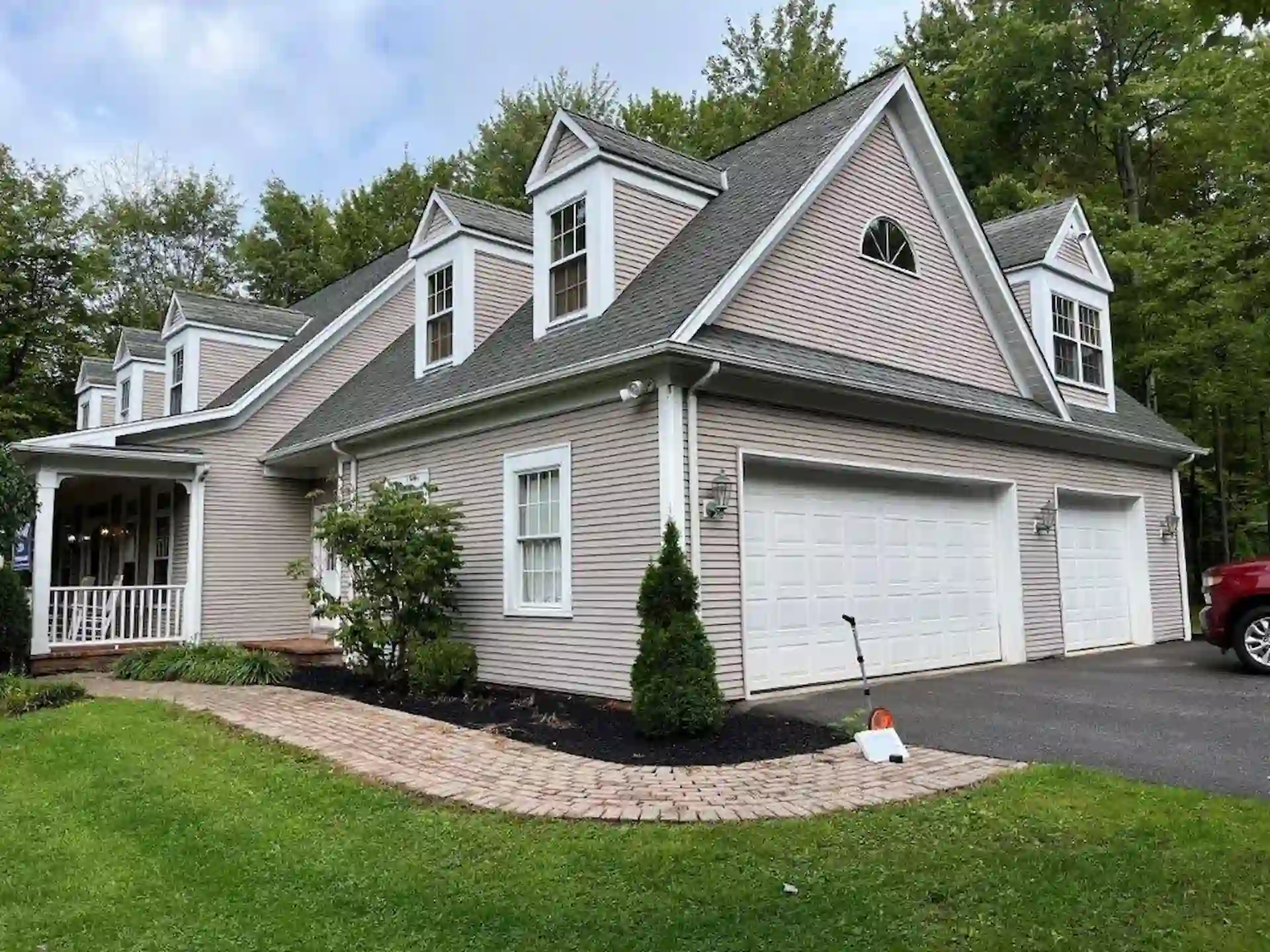 front yard and entry way of home with new tan vinyl siding