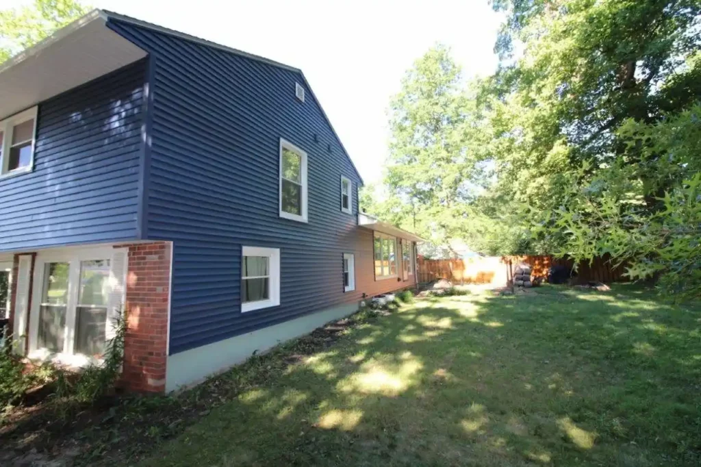 side of a home with brand new blue vinyl siding showing exterior armors good work